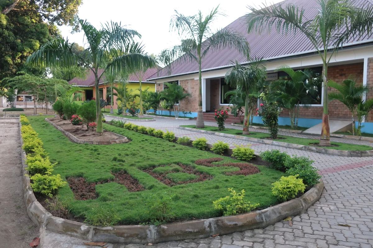 HBS spelled in shrubs on the lawn of the early Kigamboni campus.